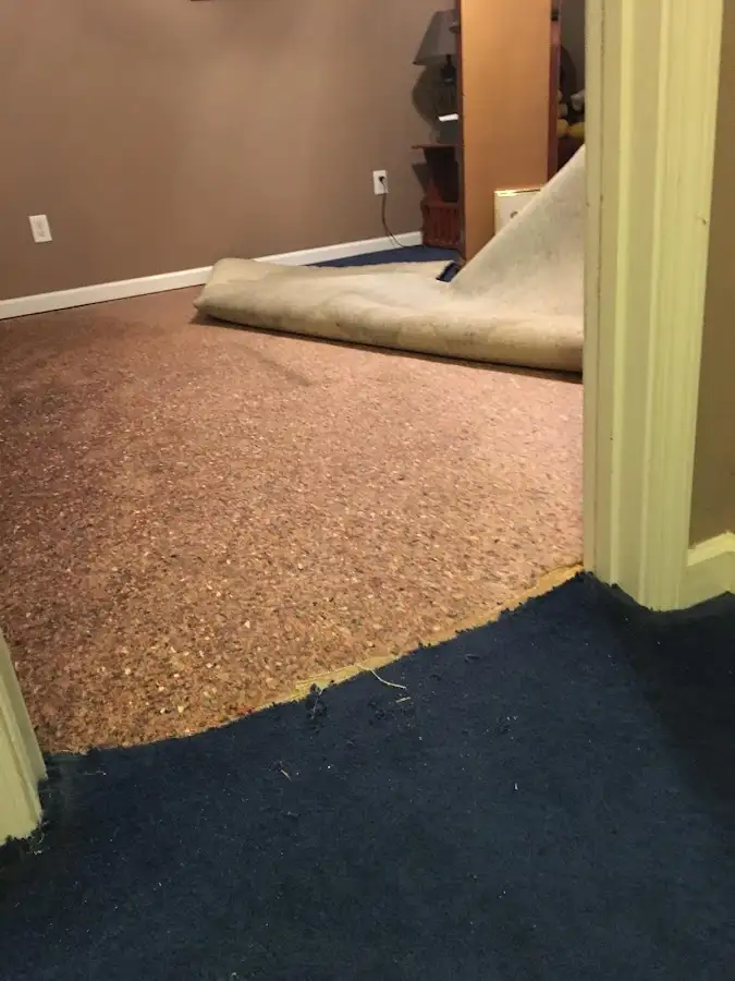 Carpet pad removal revealing water damage during Water Mitigation Services in Rowland Heights